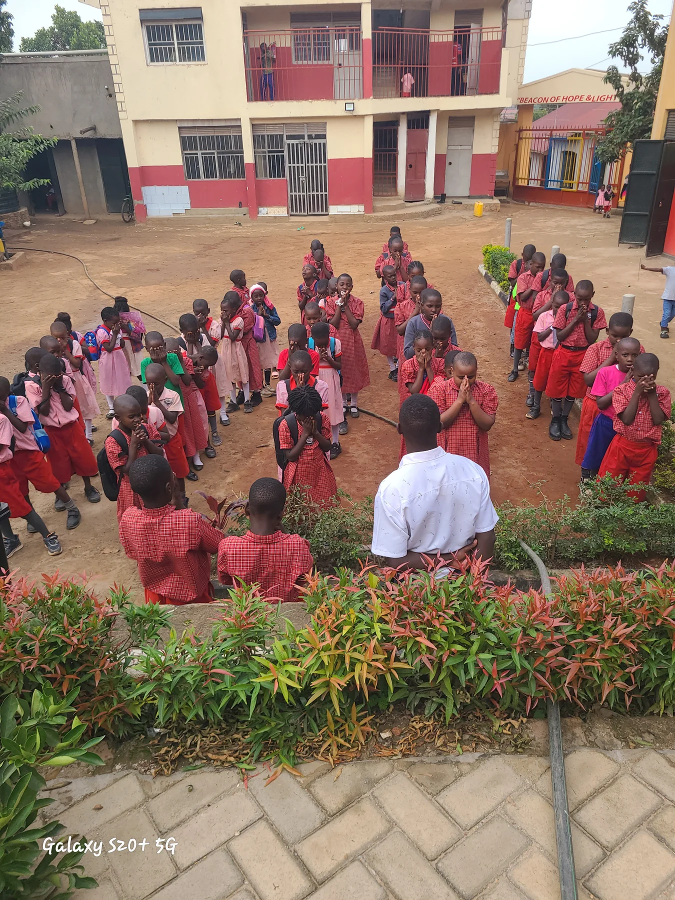 Children and staff in the courtyard in front of St. Keren Junior School